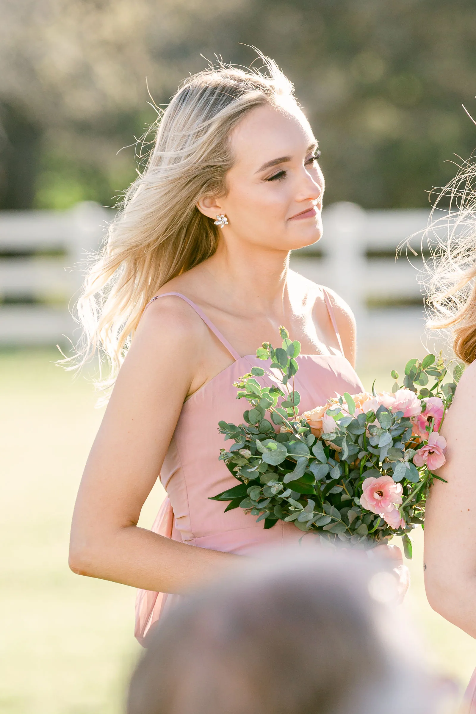 Emotional ceremony moment photographed beautifully despite bare early-spring branches.