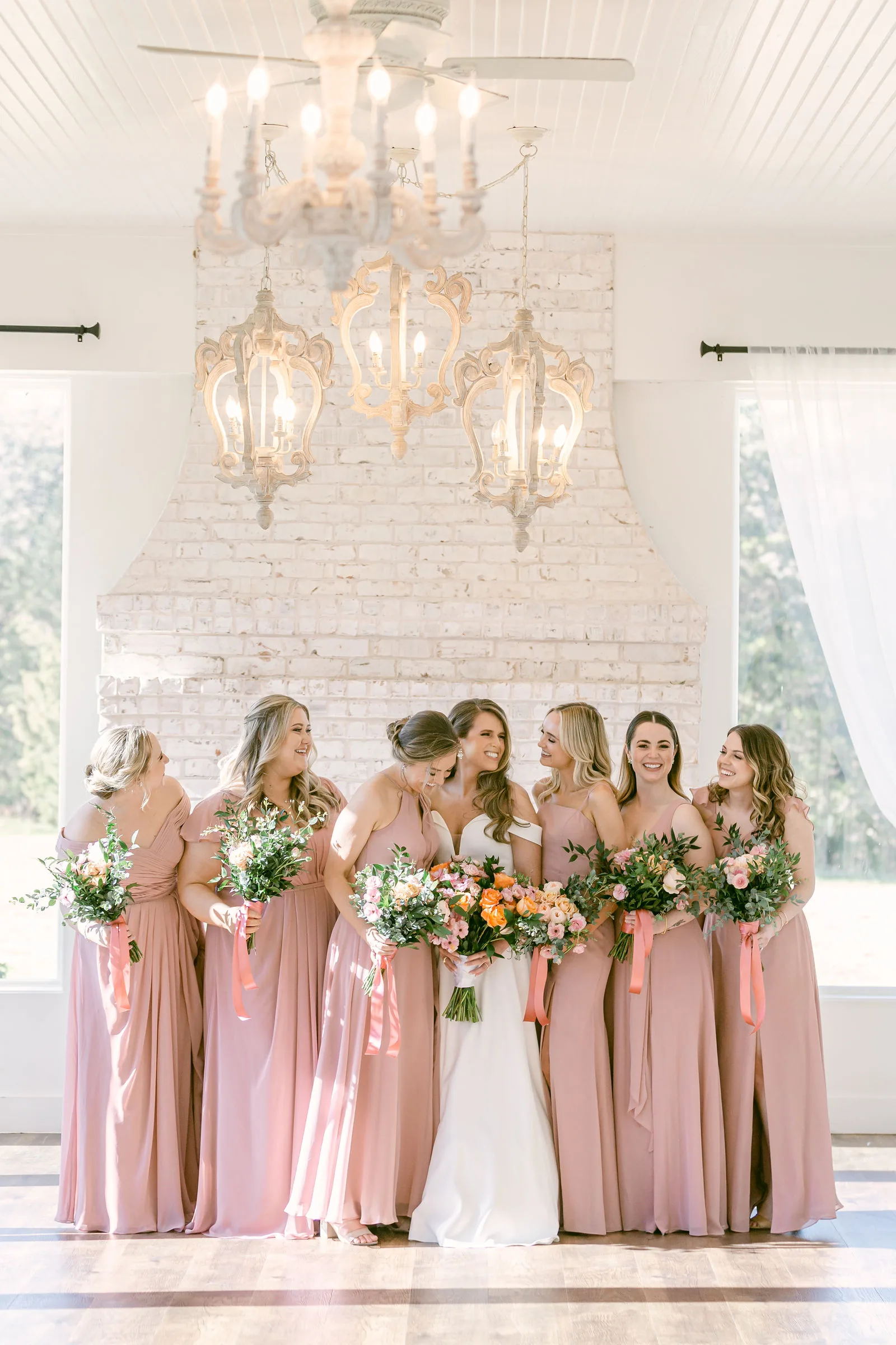 Wedding party portrait showing the Cocktail Patio fireplace and room setting.